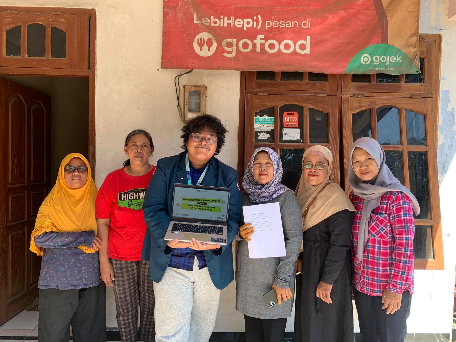 A group of people standing in front of a building AI-generated content may be incorrect.